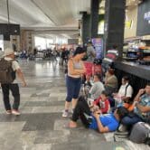 Venezuelan migrants sit on the floor at a Mexico City bus terminal