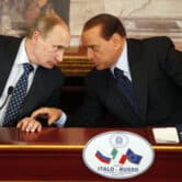 Vladimir Putin and Silvio Berlusconi talk during a press conference in Italy.