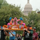 Marchers walk Day of the Dead altar away from the Texas capitol