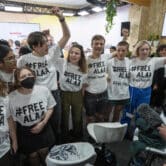 Protesters wearing T-shirts with #FREEALAA drawn on them attend the COP27 U.N. Climate Summit in Egypt.