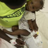 A baby stricken with cholera receives treatment at a clinic in Haiti.