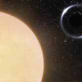 An illustration of a black hole and sun-like star binary system called Gaia BH1.