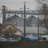 Police officers work outside a grain depot in Poland.