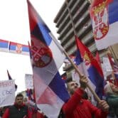 Kosovo Serbs wave Serbian flags during a protest