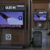 TV screens in South Korea show a file image of a North Korean missile launch.