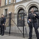 Police officers stand watch outside the United Synagogue of Hoboken.