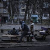 Residents repair a bench in Ukraine.