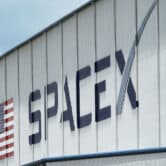 The SpaceX logo is displayed on a building.