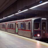 A subway train stopped at a station.