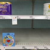 Baby formula is displayed on the shelves of a grocery store.