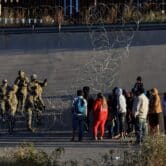 U.S. military members stop migrants from crossing into El Paso, Texas.