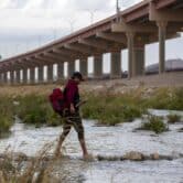 A migrant crosses the Rio Grande from Mexico into the U.S.