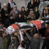 Palestinians carry the body of a slain teenager during her funeral.