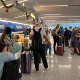 Southwest Airlines passengers wait for baggage after canceled flights at Los Angeles International Airport
