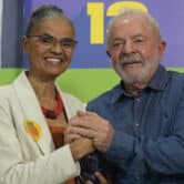 Marina Silva and Luiz Inacio Lula da Silva hold hands during an event in Brazil.