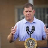 Marty Walsh speaks behind a lectern at an event.