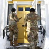 National guard members check on residents in Buffalo after a blizzard.