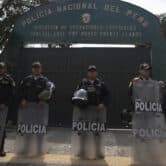 Guards stand outside the National Police base in Lima, Peru.