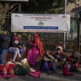 Patients wait outside a hospital in India.