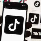 The TikTok logo is seen on a cell phone.