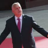 Viktor Orban gestures after arriving in Albania for a summit.