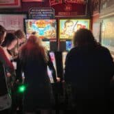 Bar patrons play pinball in Charleston, South Carolina.