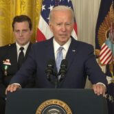 Biden stands at White House podium