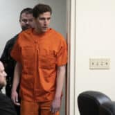 Bryan Kohberger enters an Idaho courtroom wearing an orange prison jumpsuit.