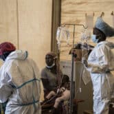 Health workers in protective gear treat cholera patients at a hospital in Malawi.