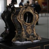 A damaged 17th-century clock stands on display at the Planalto Palace in Brazil.