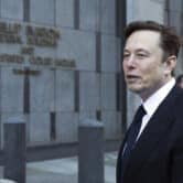 Elon Musk leaves court in a suit in San Francisco.