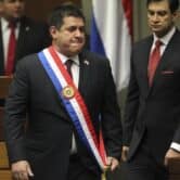 Horacio Cartes arrives at Paraguay's Congress for a ceremony wearing the presidential sash.