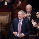 Lawmakers applaud while Kevin McCarthy stands and smiles in the U.S. House chamber.