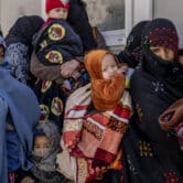 Mothers line up with their children in Afghanistan.