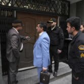 Five men stand outside the front door of the Azerbaijan Embassy in Tehran.