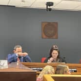 Republican representative from Scottsdale Alexander Kolodin holds his hands in front of his face in a house committee meeting Wednesday afternoon.