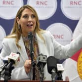 Ronna McDaniel gestures while speaking on stage at an event in Florida.
