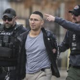 Solomon Peña is taken into custody by two Albuquerque Police officers.
