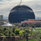 Building that looks like a ball is seen in a photo taken from the Encore guest parking garage. A golf course is in the foreground.