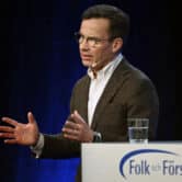 Ulf Kristersson speaks on stage during a conference in Sweden.