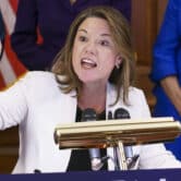 Angie Craig gestures while speaking during an event at the U.S. Capitol.