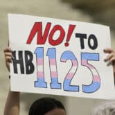 A protester holds a poster that reads "NO! TO HB 1125."