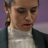 Irene Montero looks down during a press conference.