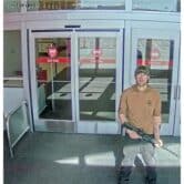 A man holds an AR-15-style rifle at the entrance of a Target store.