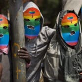 Gay and lesbian Kenyans wear rainbow masks during a protest.