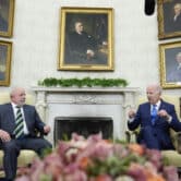 Luiz Inácio Lula da Silva and Joe Biden sit down during a meeting in the Oval Office of the White House.