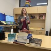 A mental health court commissioner stands behind her desk, explaining her role in the Maricopa County probate and mental health department.