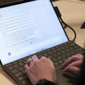 A person types on a laptop while using Microsoft's Edge browser.