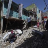 People in Peru search for their belongings after a landslide destroyed their homes.
