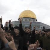 Palestinians protest outside the Dome of the Rock shrine.